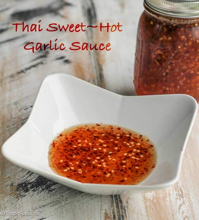 Thai Sweet Hot Garlic Sauce is very easy and lasts forever in the fridge. It is a necessity for spring rolls, and delicious on grilled chicken, pad Thai, fried rice, and a host of other dishes as well. 