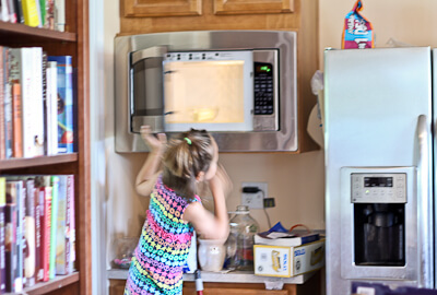 My daughter uses the microwave on a stool while baking.