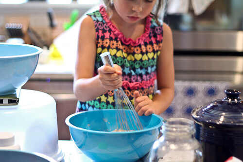 My daughter whisking the dry ingredients for muffins.
