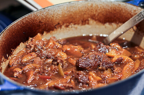 Braised beef chuck in dutch oven with Persian spices and peaches