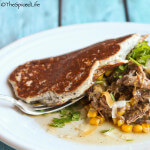 Braised Brisket with Corn and Shredded Cheese on Bacon Ricotta Corn Cakes