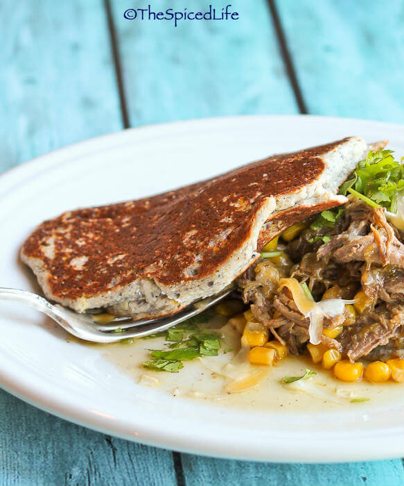 Braised Brisket with Corn and Shredded Cheese on Bacon Ricotta Corn Cakes