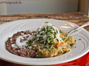 Chilaquiles Verde (tortilla chips cooked in tomatillo salsa) with Sweet Potatoes. Served with Refried Beans.