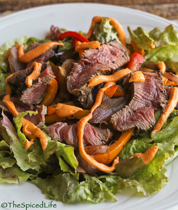 Marinated steak salad with roasted peppers and onions, and a tangy Romesco dressing.