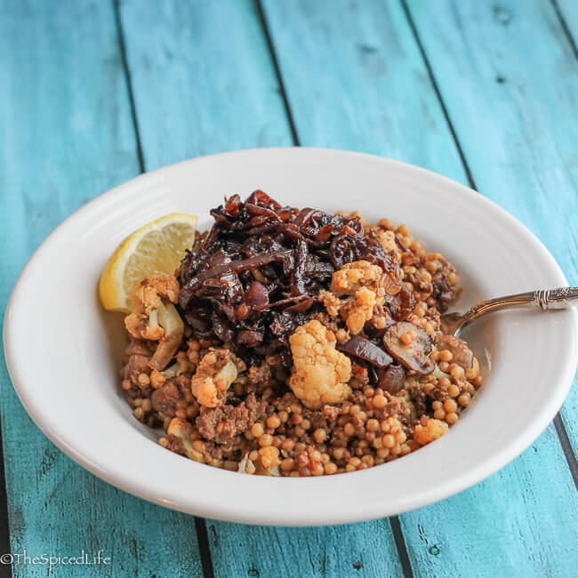 Moroccan Inspired Couscous Bowl: ground beef, cauliflower, mushrooms and dried fruit on Israeli Couscous , topped with Caramelized Onions. Fast and delicious!