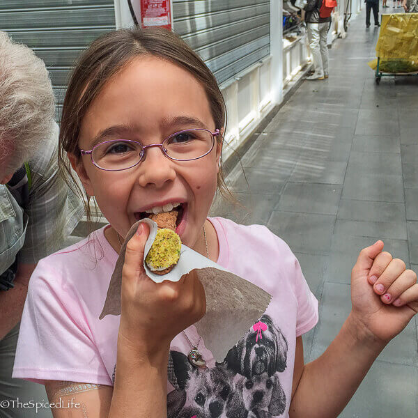 Child eating a connolo on food tour in Rome