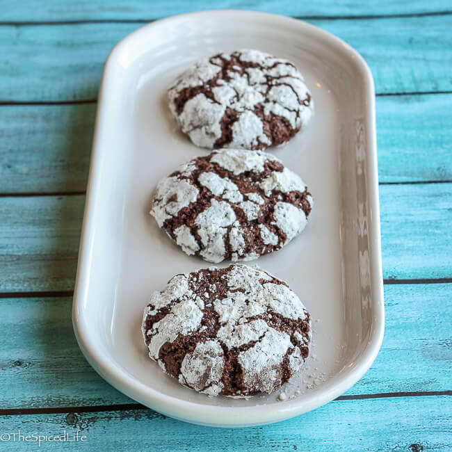Nibby Chocolate Crinkles: scrumptious dark chocolate cookies filled with cacao nibs and rolled in powdered sugar! And unlike most crinkle cookies, not at all too sweet!!!!