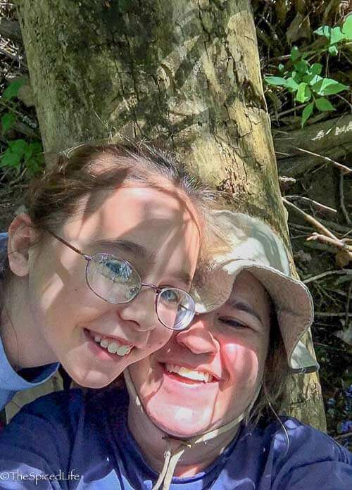 Mom and Daughter selfie lying on a log in a creek