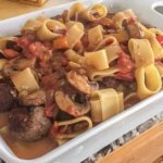 layering pasta and meatballs in casserole dish